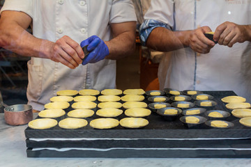 Confectioners making dough for the famous Portuguese cake "Pastel de Nata"