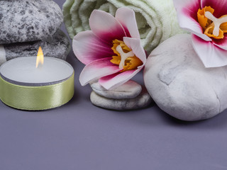 Spa set with stones, candle, orchid flowers