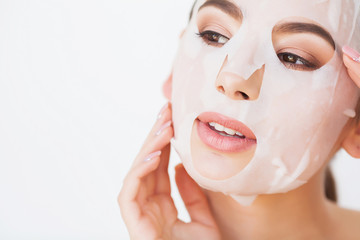 Spa Woman applying Facial cleansing Mask. Beauty Treatments