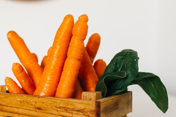 Carrots in wooden crate with white background