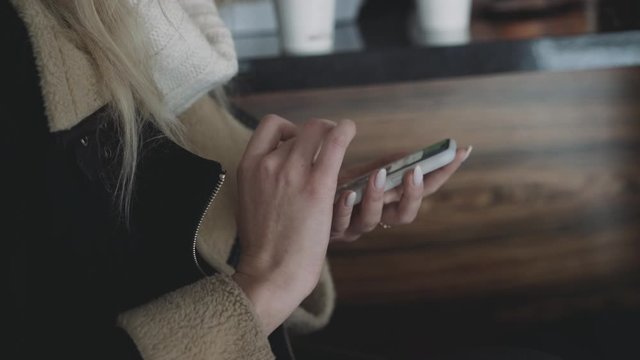 Female hand using smartphone indoor