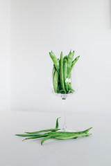 green beans in glass with white background