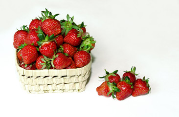 ripe and tasty strawberries in a wicker bowl
