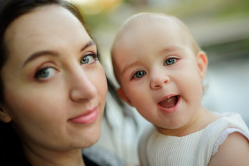 happy family mother and child little daughter running and playing on autumn walk