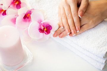 Obraz na płótnie Canvas Beautiful woman's nails with french manicure, in beauty studio