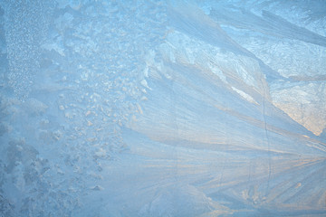 Fototapeta na wymiar beautiful winter texture patterns of frost on window