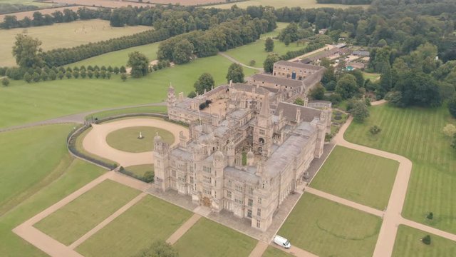 Aerial drone shot of Burghley House, a grand sixteenth-century country house, & surrounding countryside in England