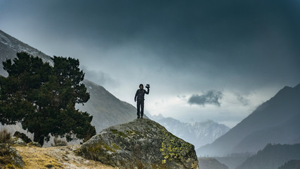Male photographer in mountains, during winter.