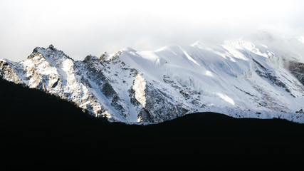 Fototapeta na wymiar Beautiful Himalaya mountains covered with snow and wrapped in fog, Manaslu Circuit Trek.