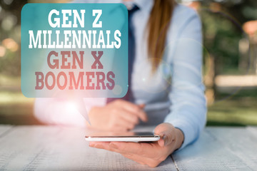 Writing note showing Gen Z Millennials Gen X Boomers. Business concept for Generational differences Old Young showing Female business person sitting by table and holding mobile phone
