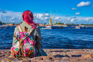 Saint Petersburg. Russia. Peter-Pavel's Fortress. A girl admires the Peter and Paul Fortress. Girl on the embankment of St. Petersburg. Tourist in Petersburg. Neva. Traveling in Russia