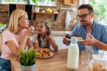 Happy family having breakfast at home