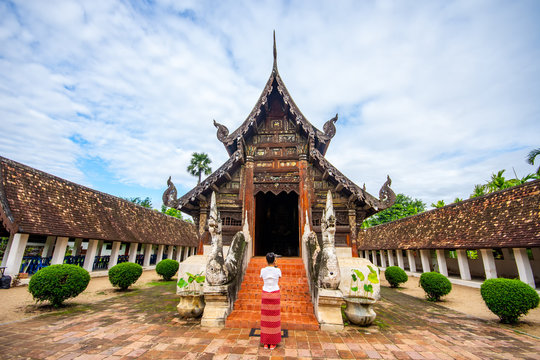 Young grils traveling take photo Wat Ton Kain, Old temple made from wood know as landmark of city located in Chiang Mai Thailand