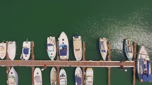 Aerial, top down, drone shot, over boats and yachts, parked at Olhao marina, on a sunny day, in Algarve, Portugal