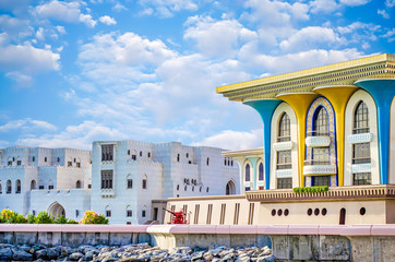 Fototapeta premium Colorful palace with marble buildings facing the sea. From Muscat, Oman.