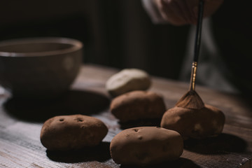 cooking potato cake on a dark wooden background. cooking rum ball