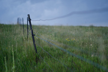 Fototapeta premium Fence in Stormy Farm Land