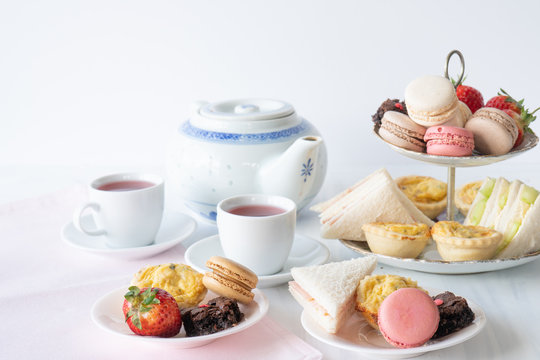High Tea with Macaroons, Sandwiches, Quiche, Brownies and Strawberries with Tea Horizontal