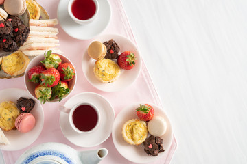 Setting of High Tea from Above with Copy Space with Macaroons, Brownies, Quiche, Sandwiches, and Tea
