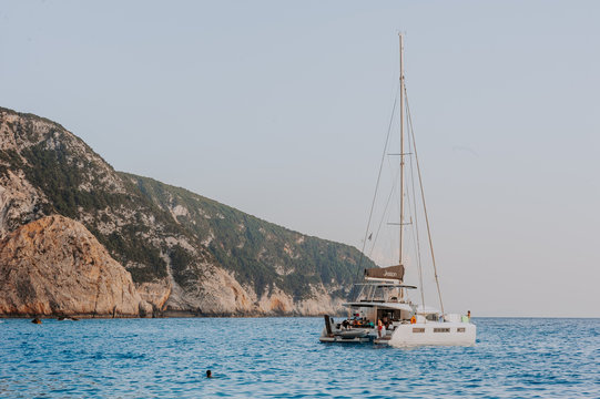 Sailing yaht in open sea on beautiful sunset sky background. yaht on beautiful beach Porto Katsiki Lefkada