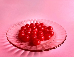 Delicious red candies on pink background