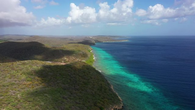 Aerial view of coast of Curaçao in the Caribbean Sea with turquoise water, cliff, beach and beautiful coral reef around Playa Hundu