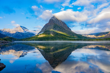 Naklejka na ściany i meble Sunrise of the Mount Wilbur, Swiftcurrent Lake in the Many Glacier area of the famous Glacier National Park