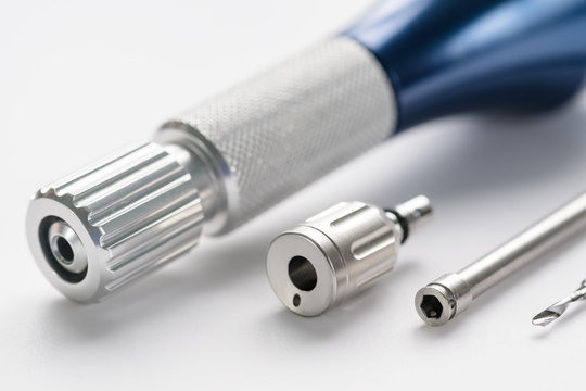 Closeup/ Implant surgical kits/ mini screw/ screw driver/ drilling bits on white background.