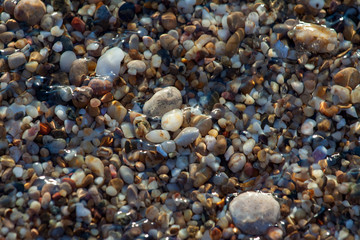 sea pebbles colored granite on the beach