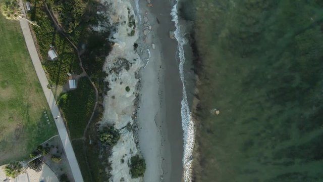 Birdseye View Of A Public Park On The Shoreline Of The Pacific Ocean During Sunset. Kids Are Playing In The Playground And There Is A Small Beach, In Santa Barbara, California,USA.