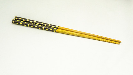 A chopsticks with polka dot pattern on a isolated white background.