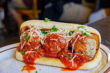 Close up shot of tomato sauce meat ball sandwich