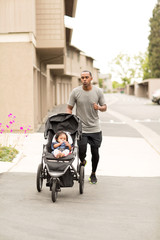 Father exercising and taking his daughter for a jog.