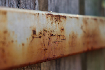 rust on the back of a wooden fence