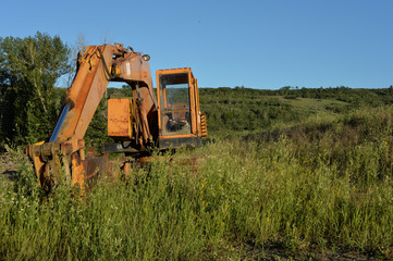 Abandoned construction equipment in field