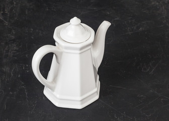 white coffee pot on black rustic background table 