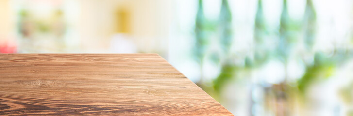 wood table top product display background with blur people in green cafe restaurant.left...