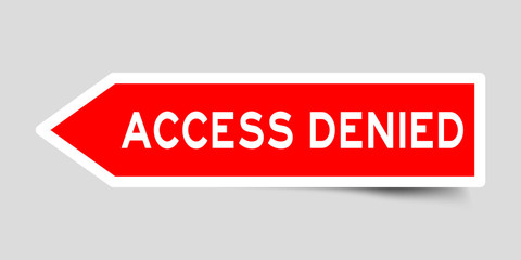 Red color arrow sticker with word access denied on gray background