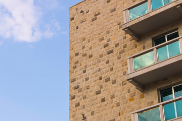 Part of the building against the blue sky. The wall against the blue sky.