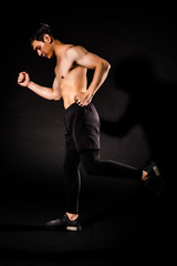 sport man running and and showing muscle bodybuilding on black backgrounds, fitness concept, sport concept