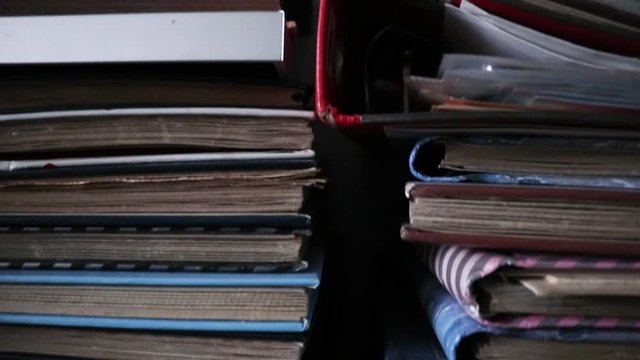 Moving shot of old books, folders and documents.