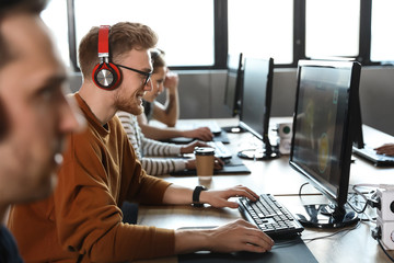 Man playing video game in internet cafe
