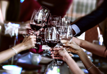 Red wine friends at the party, of out focus