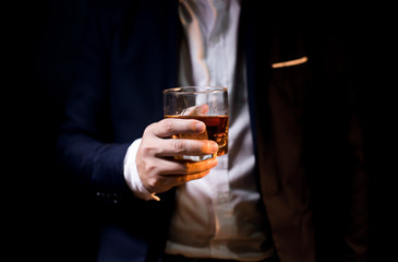 Closeup businessmen holding a glass of whiskey