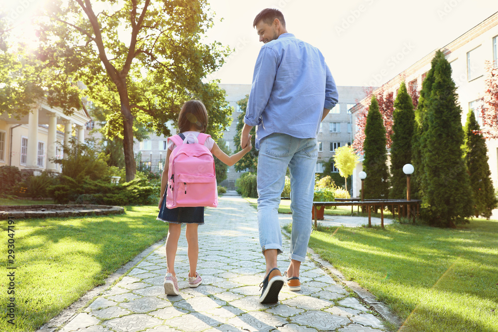 Canvas Prints Father taking his little child to school through park