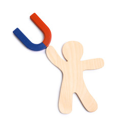 Red and blue horseshoe magnet with wooden human figure on white background, top view