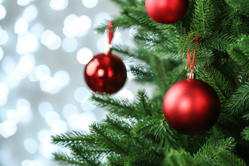 Decorated Christmas tree against blurred lights on background. Bokeh effect