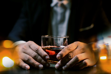 Closeup businessmen holding a glass of whiskey
