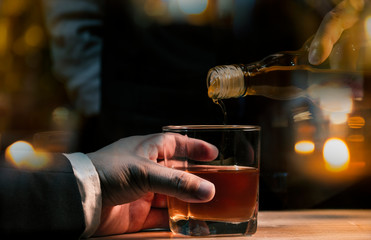 Fototapeta na wymiar Bartender Serve Whiskey, on wood bar, 