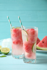 Delicious refreshing watermelon drink on blue wooden table, above view